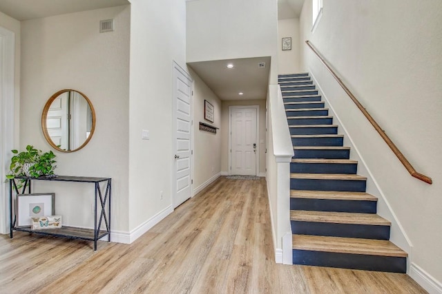 336 Gaida Loop, Georgetown, TX 78628 - stairway featuring wood finished floors, recessed lighting, and a towering ceiling
