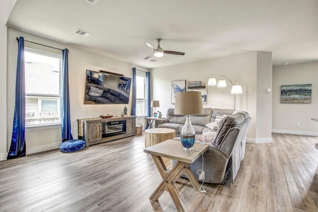 336 Gaida Loop, Georgetown, TX 78628 - living area featuring ceiling fan, wood finished floors, and a glass covered fireplace
