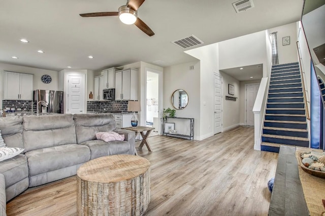 336 Gaida Loop, Georgetown, TX 78628 - living area with ceiling fan, stairs, light wood-type flooring, and recessed lighting