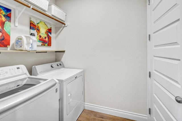 336 Gaida Loop, Georgetown, TX 78628 - laundry room featuring washing machine and dryer and wood finished floors