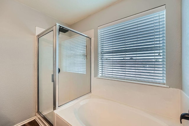 14418 Cummins Way, Manor, TX 78653 - full bath with a garden tub, a shower stall, and plenty of natural light