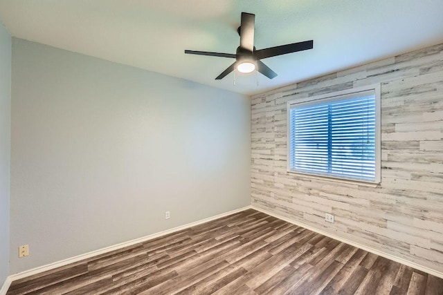 14418 Cummins Way, Manor, TX 78653 - empty room featuring ceiling fan, wood finished floors, and wooden walls