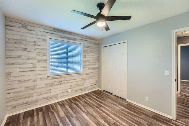 14418 Cummins Way, Manor, TX 78653 - unfurnished bedroom featuring wood finished floors, a closet, and a ceiling fan