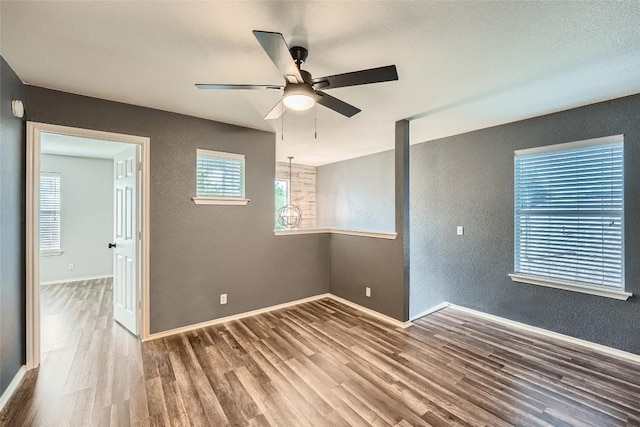 14418 Cummins Way, Manor, TX 78653 - spare room with a textured wall, wood finished floors, and ceiling fan