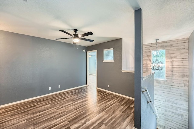 14418 Cummins Way, Manor, TX 78653 - unfurnished room with wood finished floors, a ceiling fan, and a textured ceiling