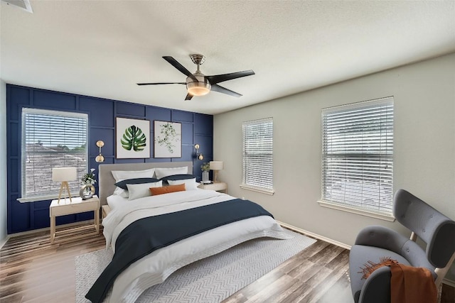 14418 Cummins Way, Manor, TX 78653 - bedroom with wood finished floors and a ceiling fan