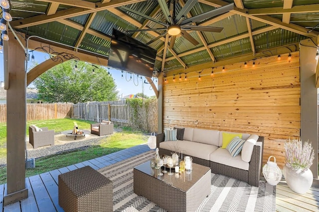 14418 Cummins Way, Manor, TX 78653 - fenced backyard featuring an outdoor living space with a fire pit, a gazebo, a wooden deck, and a ceiling fan