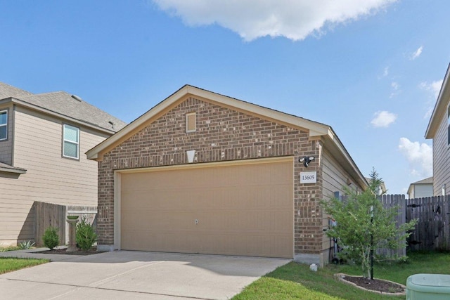 13605 Abigail Adams St, Manor, TX 78653 - view of front of house with brick siding, driveway, and an attached garage