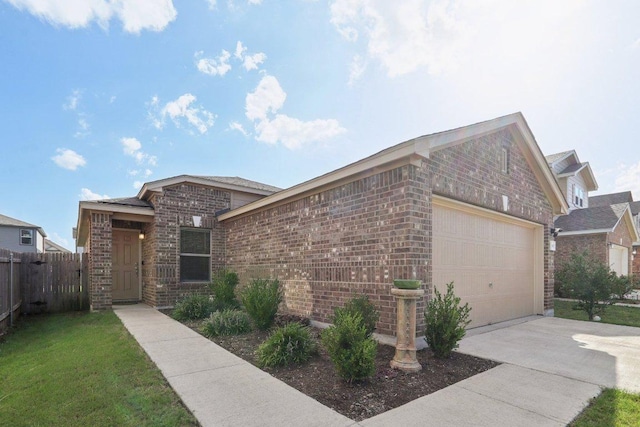 13605 Abigail Adams St, Manor, TX 78653 - view of front facade featuring brick siding, driveway, and a garage