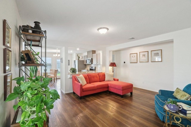 13605 Abigail Adams St, Manor, TX 78653 - living area featuring a chandelier and dark wood-style floors
