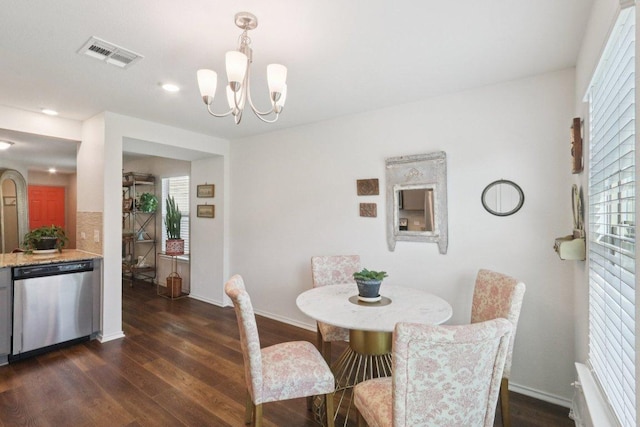 13605 Abigail Adams St, Manor, TX 78653 - dining room with dark wood finished floors, a chandelier, and plenty of natural light