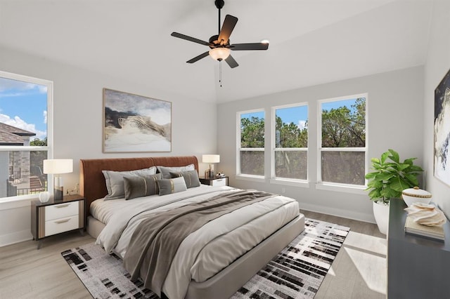 5126 Destination Way, Jonestown, TX 78645 - bedroom with light wood-style floors, lofted ceiling, and ceiling fan
