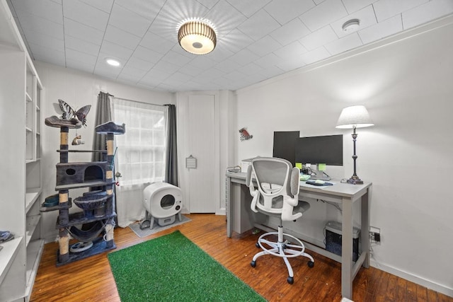 707 Wilson St, Taylor, TX 76574 - office area featuring wood finished floors and baseboards