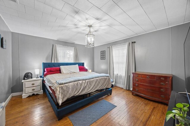 707 Wilson St, Taylor, TX 76574 - bedroom with multiple windows and wood-type flooring