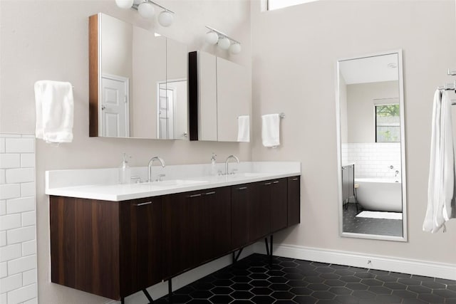 5710 Marilyn Dr, Austin, TX 78757 - full bath featuring double vanity, a soaking tub, and tile patterned floors