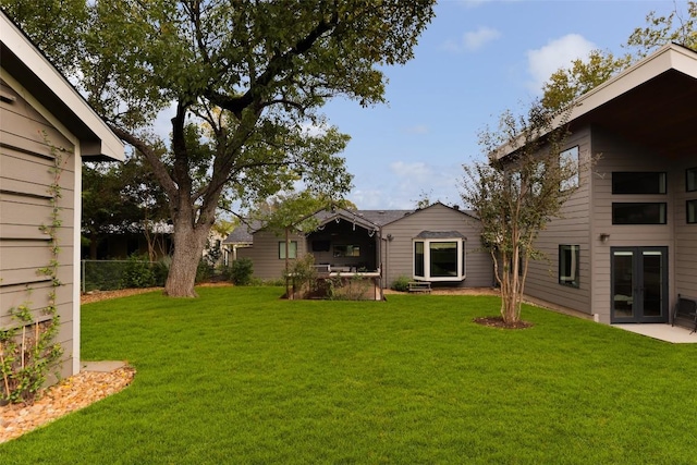 5710 Marilyn Dr, Austin, TX 78757 - view of grassy yard featuring french doors and a patio