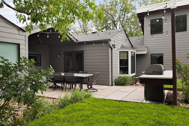5710 Marilyn Dr, Austin, TX 78757 - back of property with a patio area, a shingled roof, and a yard