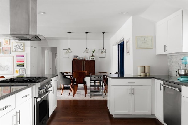 5710 Marilyn Dr, Austin, TX 78757 - kitchen with island range hood, stainless steel appliances, dark countertops, white cabinetry, and recessed lighting