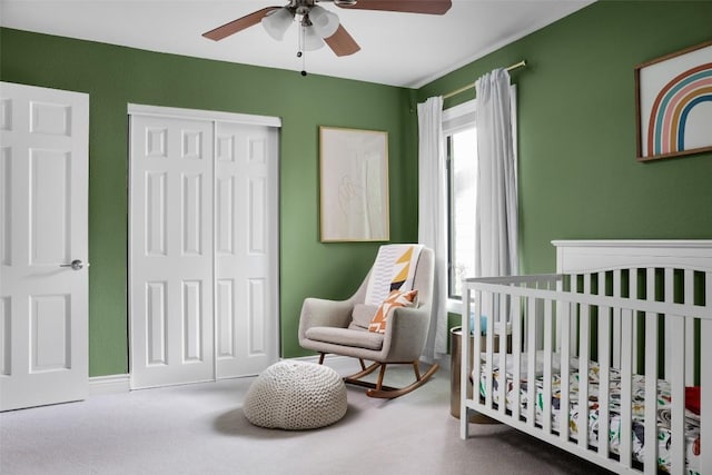5710 Marilyn Dr, Austin, TX 78757 - bedroom with a closet, a nursery area, a ceiling fan, and carpet flooring