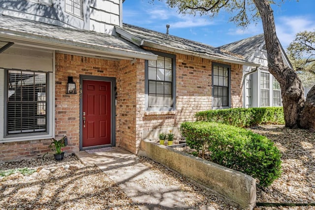 1411 Gracy Farms Ln Unit 130, Austin, TX 78758 - property entrance with brick siding and roof with shingles