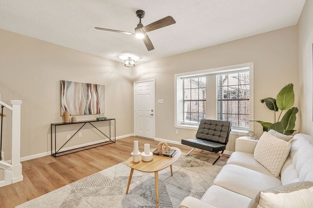 1411 Gracy Farms Ln Unit 130, Austin, TX 78758 - living room featuring wood finished floors, a ceiling fan, and a textured ceiling