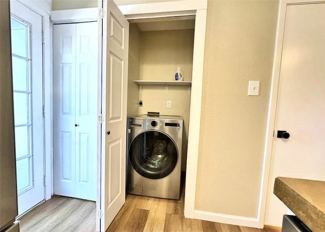 1411 Gracy Farms Ln Unit 130, Austin, TX 78758 - laundry room with washer / dryer and light wood-style flooring