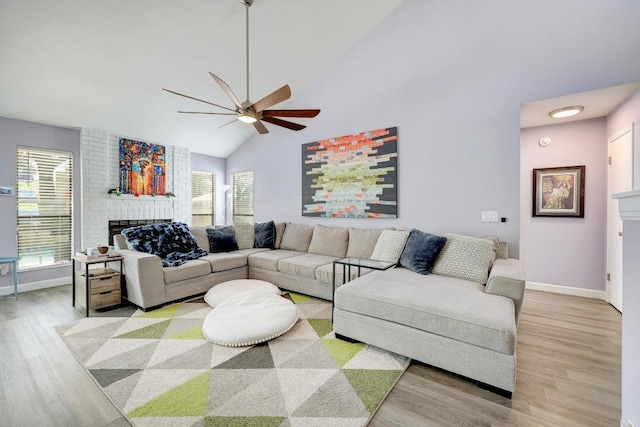 402 Oakcrest Dr, Cedar Park, TX 78613 - living area with a brick fireplace, ceiling fan, light wood-style flooring, high vaulted ceiling, and healthy amount of natural light