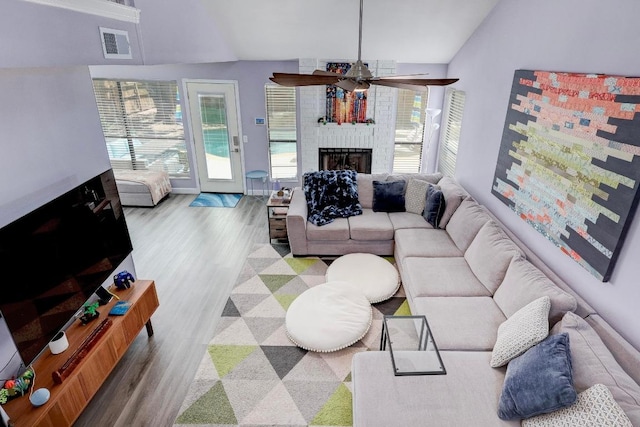 402 Oakcrest Dr, Cedar Park, TX 78613 - living area with a ceiling fan, vaulted ceiling, plenty of natural light, wood finished floors, and a brick fireplace
