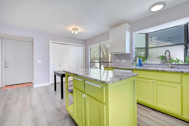 402 Oakcrest Dr, Cedar Park, TX 78613 - kitchen with light wood finished floors, green cabinets, a kitchen island, and light stone countertops