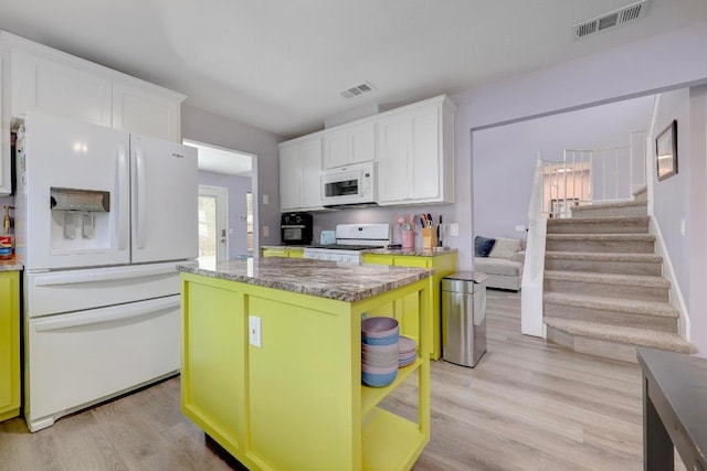 402 Oakcrest Dr, Cedar Park, TX 78613 - kitchen featuring white appliances, white cabinets, light wood-type flooring, and a kitchen island