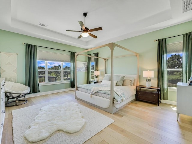 11901 Pier Ct, Austin, TX 78737 - bedroom with a raised ceiling, wood-type flooring, and ceiling fan