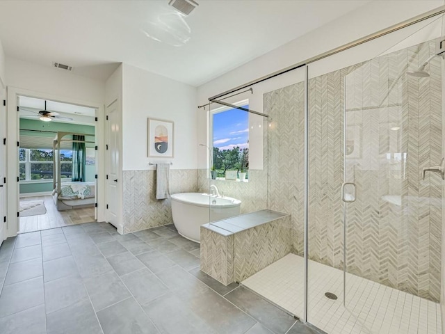 11901 Pier Ct, Austin, TX 78737 - bathroom featuring tile walls, healthy amount of natural light, a freestanding tub, a shower stall, and ceiling fan
