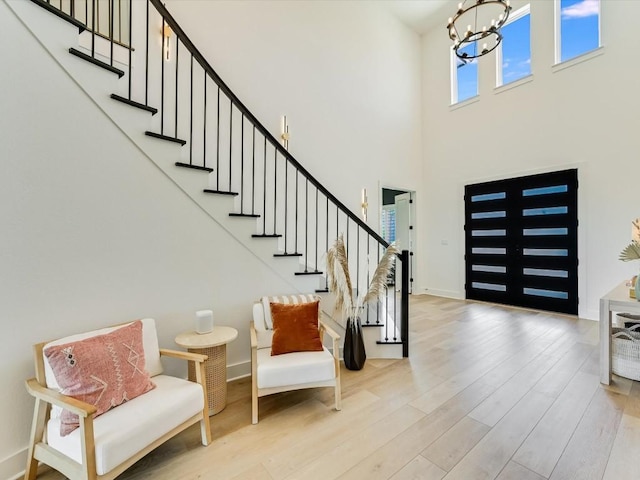 11901 Pier Ct, Austin, TX 78737 - entryway with a chandelier, wood finished floors, stairs, and a towering ceiling