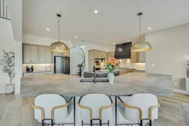 11901 Pier Ct, Austin, TX 78737 - kitchen featuring appliances with stainless steel finishes, custom range hood, a large island, backsplash, and recessed lighting