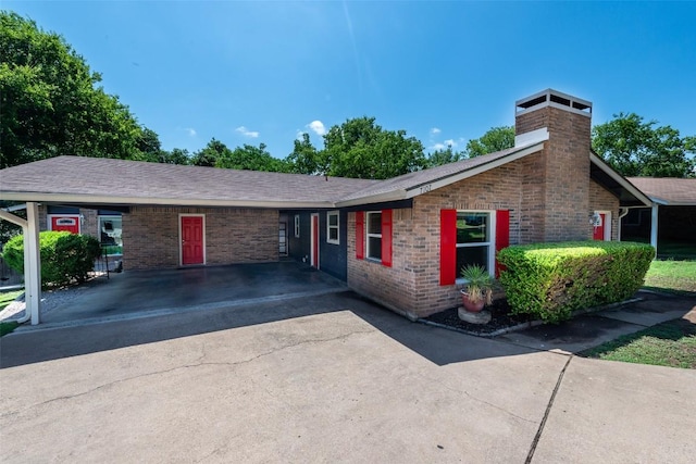 7107 Dan Jean Dr Unit A & B, Austin, TX 78745 - single story home featuring a chimney, brick siding, asphalt driveway, and a carport