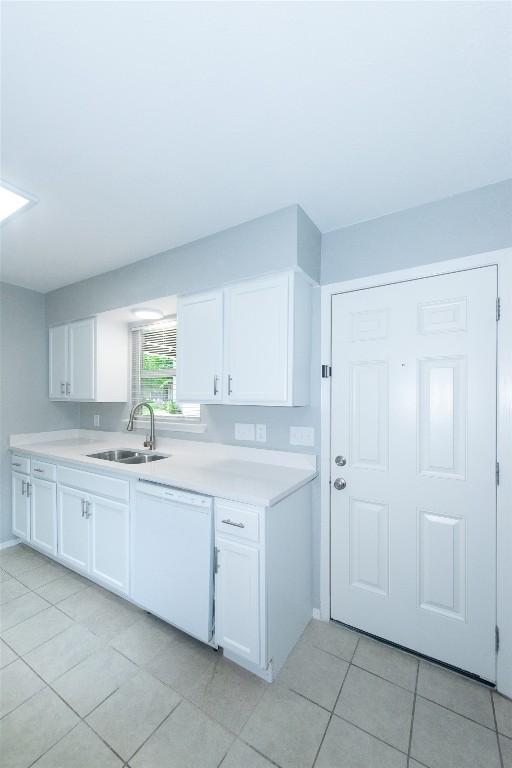 7107 Dan Jean Dr Unit A & B, Austin, TX 78745 - kitchen with white dishwasher, light countertops, light tile patterned floors, and white cabinets