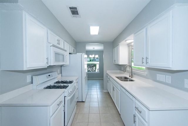 7107 Dan Jean Dr Unit A & B, Austin, TX 78745 - kitchen with white appliances, white cabinets, a chandelier, and light countertops