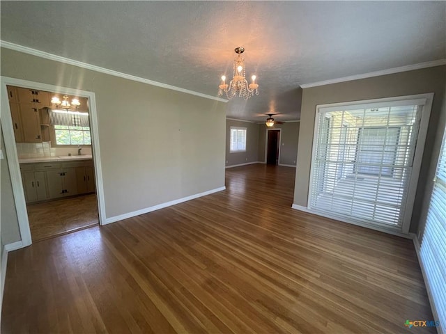 601 S Arnold St S, Lampasas, TX 76550 - unfurnished dining area featuring a chandelier, dark wood finished floors, plenty of natural light, and ornamental molding