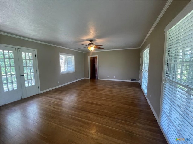 601 S Arnold St S, Lampasas, TX 76550 - empty room featuring dark wood-type flooring, a ceiling fan, crown molding, a textured ceiling, and french doors