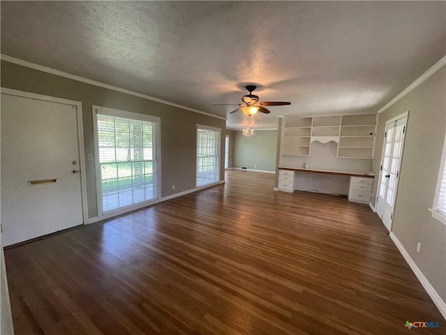 601 S Arnold St S, Lampasas, TX 76550 - unfurnished living room featuring dark wood finished floors, built in desk, a ceiling fan, ornamental molding, and a textured ceiling