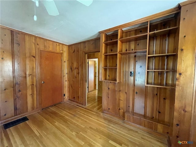 601 S Arnold St S, Lampasas, TX 76550 - unfurnished bedroom with wood finished floors, wood walls, and a closet