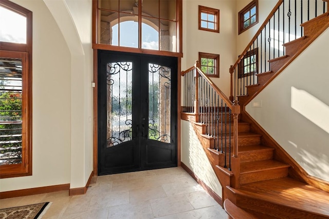 307 Goodnight Dr, Georgetown, TX 78628 - foyer with french doors, arched walkways, stairway, and a towering ceiling