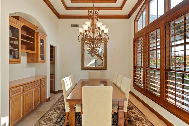 307 Goodnight Dr, Georgetown, TX 78628 - dining area featuring a chandelier, a raised ceiling, crown molding, and light tile patterned flooring