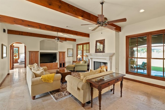 307 Goodnight Dr, Georgetown, TX 78628 - living room featuring ceiling fan, plenty of natural light, arched walkways, recessed lighting, and beamed ceiling
