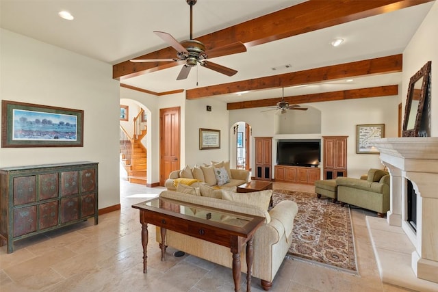 307 Goodnight Dr, Georgetown, TX 78628 - living room featuring ceiling fan, arched walkways, beamed ceiling, recessed lighting, and a fireplace