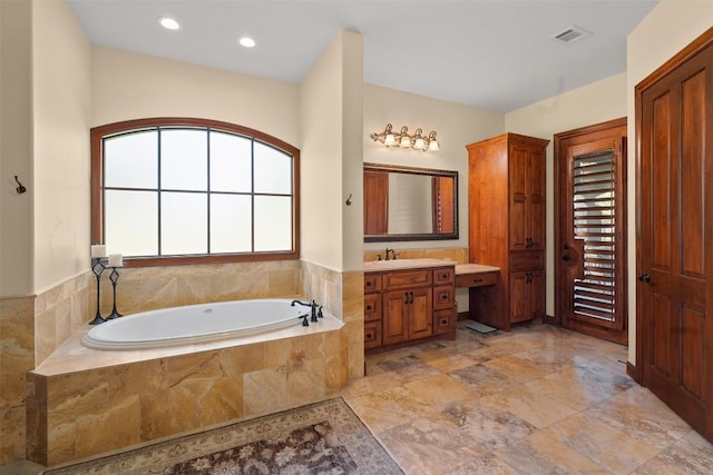 307 Goodnight Dr, Georgetown, TX 78628 - full bathroom with vanity, a garden tub, and recessed lighting
