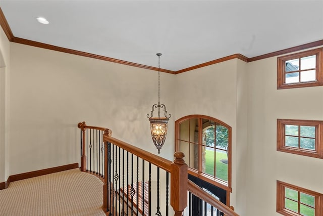 307 Goodnight Dr, Georgetown, TX 78628 - hallway featuring a chandelier, an upstairs landing, ornamental molding, and carpet floors