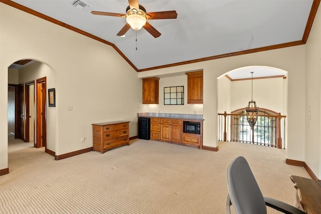 307 Goodnight Dr, Georgetown, TX 78628 - living area featuring light colored carpet, crown molding, lofted ceiling, arched walkways, and a ceiling fan