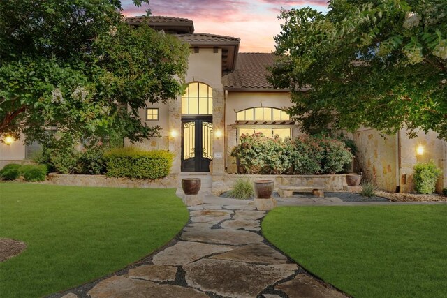 307 Goodnight Dr, Georgetown, TX 78628 - mediterranean / spanish-style house with french doors, a tiled roof, a lawn, and stucco siding