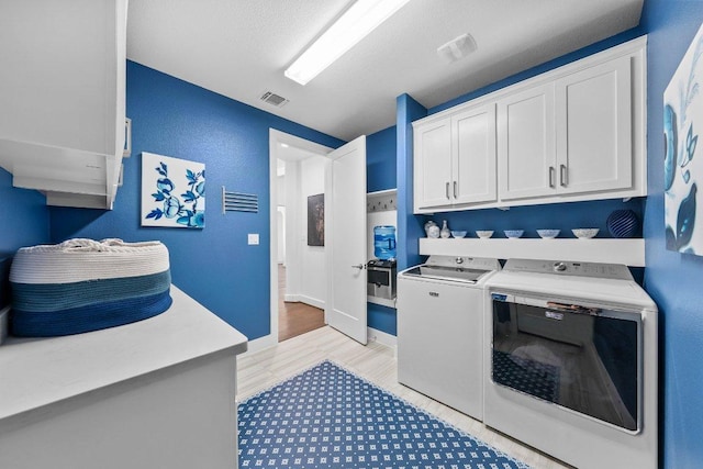 203 Black Stone Cv, Driftwood, TX 78619 - laundry area with washing machine and dryer and cabinet space